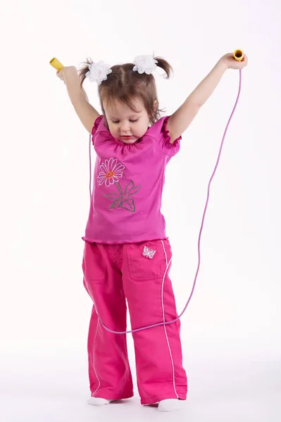Little girl with jump rope on white — Stock Photo, Image