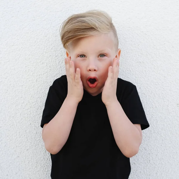 Young emotional boy on bright background — Stock Photo, Image