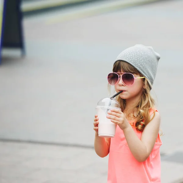 Cute little girl with milk cocktail — Stock Photo, Image