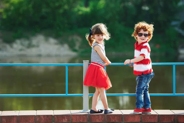 Cute little hugging children on the promenade — Stock Photo, Image