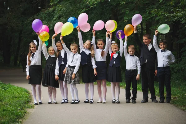 Meninos e meninas de uniforme ao ar livre — Fotografia de Stock