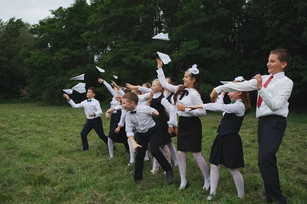 Young boys and girls in uniform outdoors — Stock Photo, Image