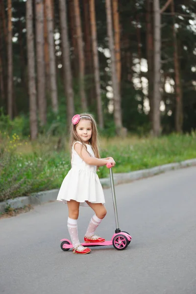 Schönes Mädchen mit Roller auf der Straße — Stockfoto