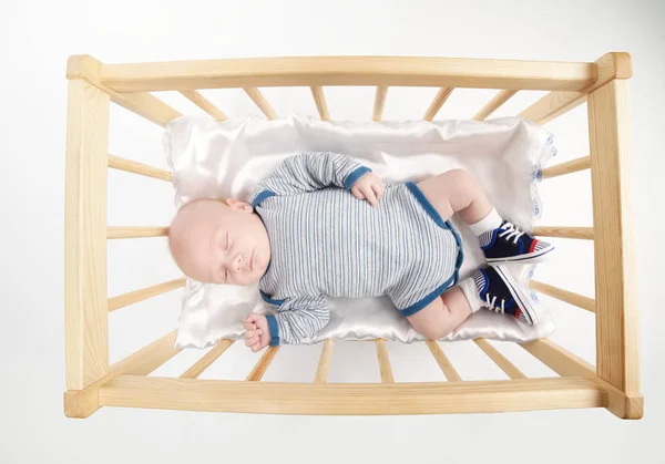 Cute newborn baby in wooden bed — Stock Photo, Image