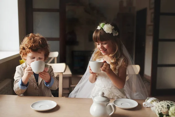Boy and girl having tea party in cafe — Stock Photo, Image