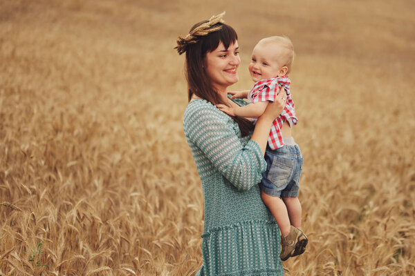 happy mother with son in the field