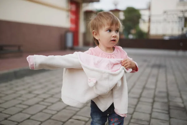 Little girl tried to get dressed wrong way — Stock Photo, Image