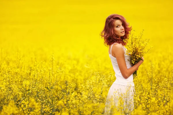 Beautiful girl in the yellow field — Stock Photo, Image