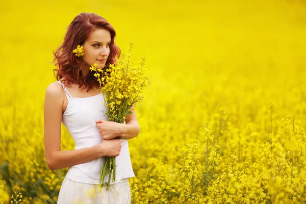 Beautiful girl in the yellow field — Stock Photo, Image