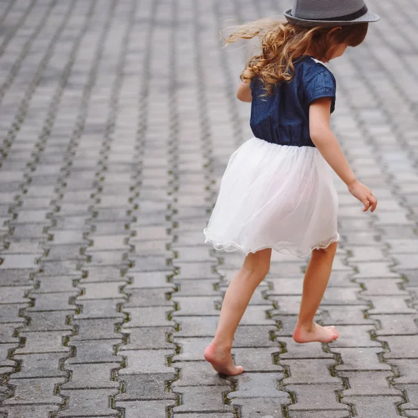 Little beautiful barefoot girl in park — Stock Photo, Image