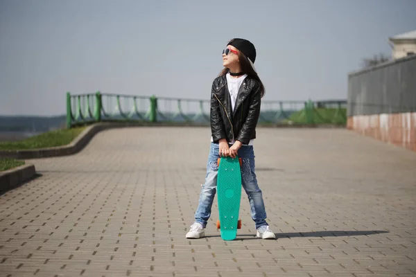 Little girl with skateboard on the street — Stock Photo, Image