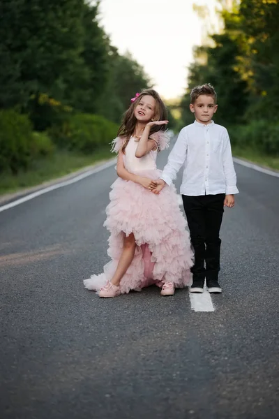 Young happy boy and girl together outside — Stock Photo, Image