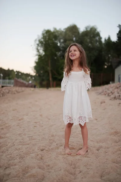 Young beautiful girl with long hair on the beach — Stock Photo, Image