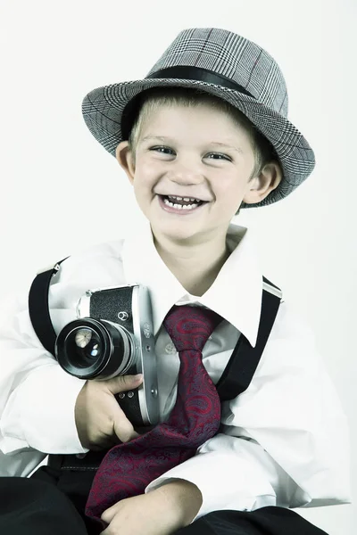 Young boy playing with old camera to be a photographer — Stock Photo, Image