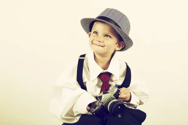 Young boy playing with old camera to be a photographer — Stock Photo, Image