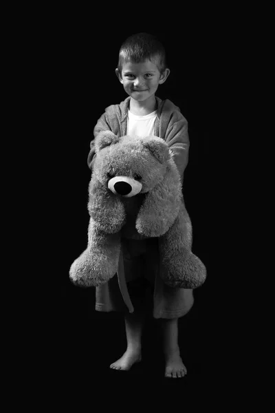 Naughty and funny boy with a teddy bear heading to sleep in arti — Stock Photo, Image