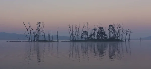 Paesaggio oscuro e cupo di un'isola su un lago — Foto Stock