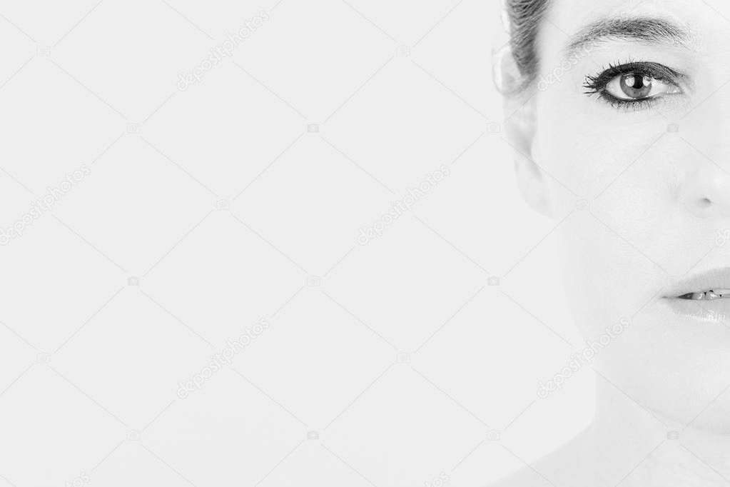 High key portrait of a woman with only half of her face