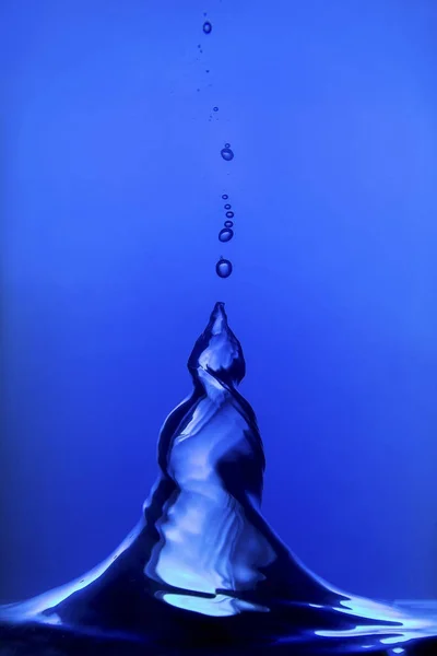 Blue water spiral of water swirling around in studio — Stock Photo, Image