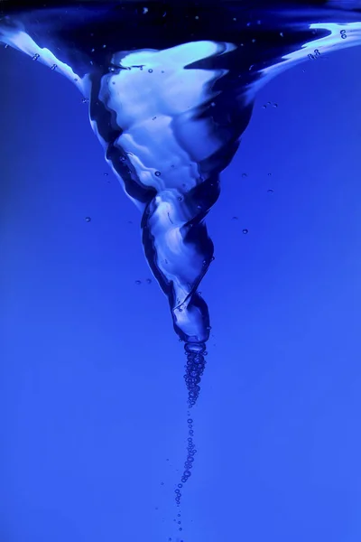 Blue water spiral of water swirling around in studio — Stock Photo, Image