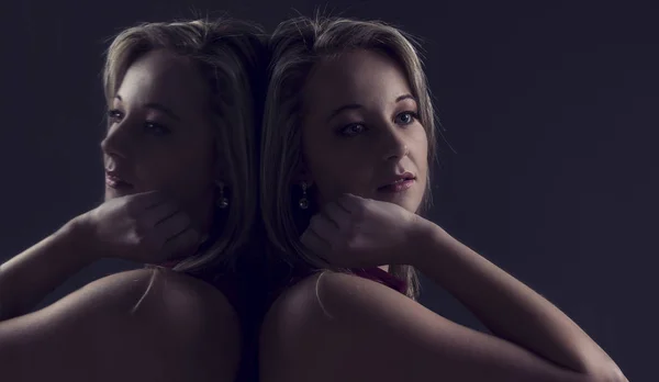 Portrait close-up of a beautiful blond woman sitting with back t — Stock Photo, Image