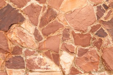 Arka plan olarak kırmızı granit taş duvar