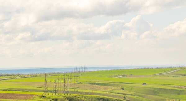 Landscape green field hills sky with clouds