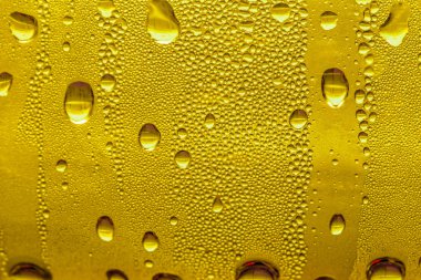 Cam su damlaları, sarı arka plan bira, buğulu arka plan.