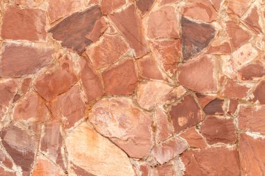 Arka plan olarak kırmızı granit taş duvar