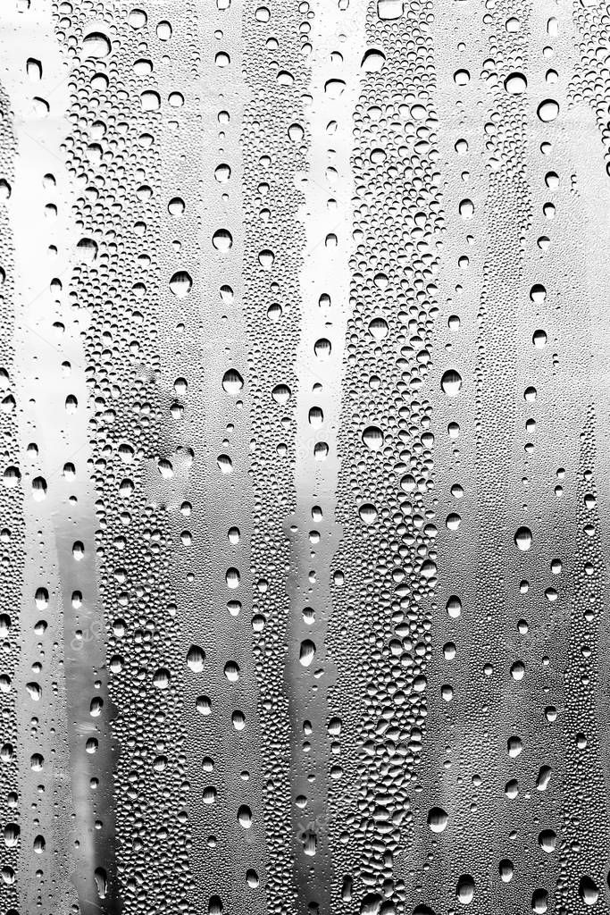 Raindrops on the glass, black-white background, fashion glass texture.