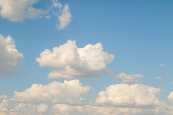 Blue sky with white beautiful cumulus clouds. Landscape sky clouds, background.