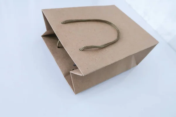 Paper bag, gray cardboard packaging on a white background. Gift bag.