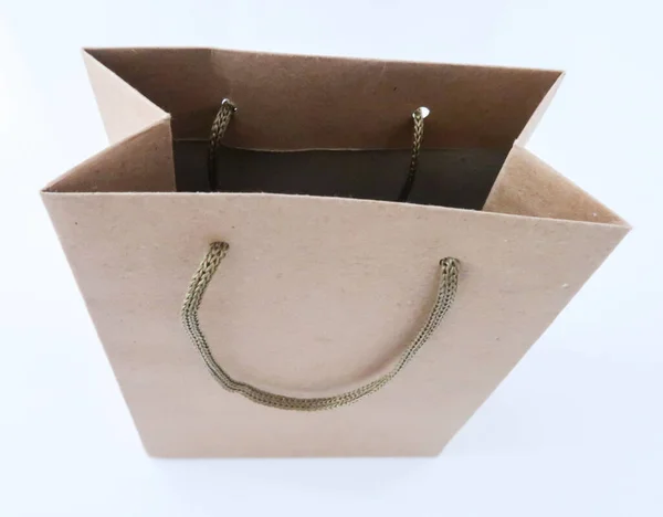Paper bag, gray cardboard packaging on a white background. Gift bag.