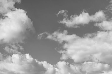 Siyah-beyaz fotoğraf, gökyüzünde beyaz desenli kabarık bulutlar.