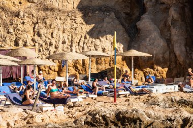 Sharm El Sheikh, Mısır - 1 Şubat 2020. Deniz kenarındaki plaj salonları, şemsiyeler, insanlar dinleniyor. Deniz kenarında yoğun bir yaz tatili. Güneşli bir gün, güneş banyosu, yüzme.