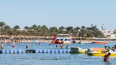 Sharm El Sheikh, Mısır - 1 Şubat 2020: Deniz kenarında yoğun bir yaz tatili. Güneşli bir günde insanlar denizde ve sahilde, güneşleniyorlar, yüzüyorlar.
