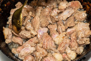 Et tavada kızartılmış ve kaşıkla karıştırılmış..