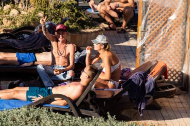 Sharm El Sheikh, Mısır - 1 Şubat 2020. Deniz kenarındaki plaj salonları, şemsiyeler, insanlar dinleniyor. Deniz kenarında yoğun bir yaz tatili. Güneşli bir gün, güneş banyosu, yüzme.