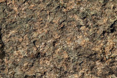 Arkaplan olarak gri kahverengi granit taş dokusu.
