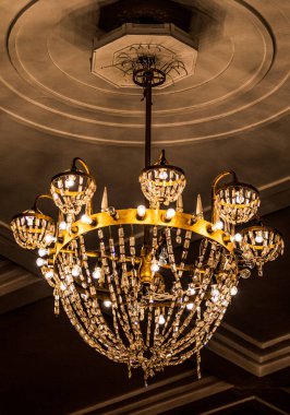 Tavanın altında büyük kristal bir avize..