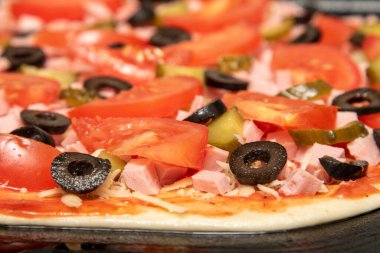 Pizza, hamur üzerinde bir sürü malzeme var..