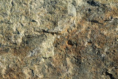 Arkaplan olarak gri kahverengi granit taş dokusu.