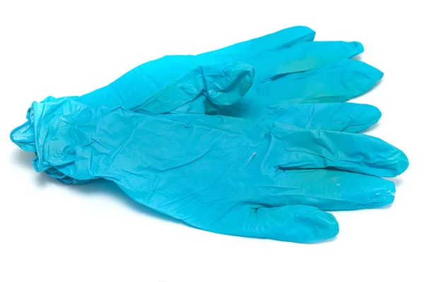 在白色背景上使用蓝色橡胶手套 — 图库照片