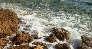 Taşlarda deniz dalgası, köpüklü sprey, yaz manzarası..