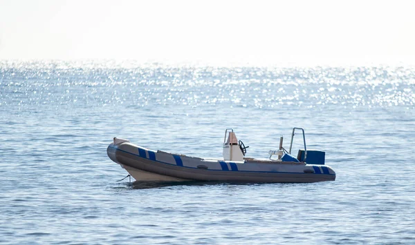 Rubber boat at sea. Inflatable boat on the expanses of the sea surface of the water.