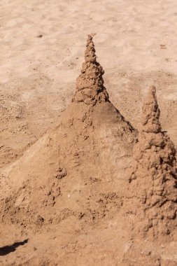 Kumla oynamak ve deniz kıyısında bir kumdan kale yapmak. Sudaki kumdan kale. Kumsaldaki kumdan kale.