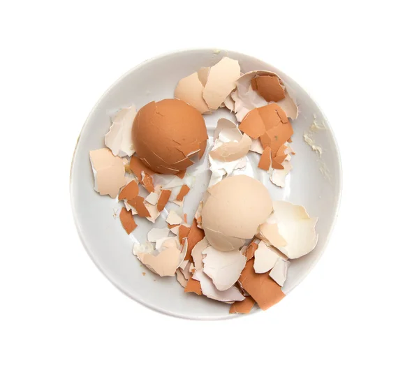 Eier Und Schalen Einem Teller Auf Weißem Hintergrund lizenzfreie Stockbilder