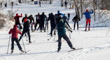 Petropavlovsk, Kazakistan - 29 Şubat 2020: Erkekler ve kadınlar, çocuklar kışın ormanda kayak yapıyor. Güneşli kış manzarası, kayak. Petropavlovsk, Kazakistan.