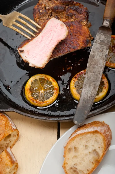 Pork chop seared on iron skillet — Stock Photo, Image