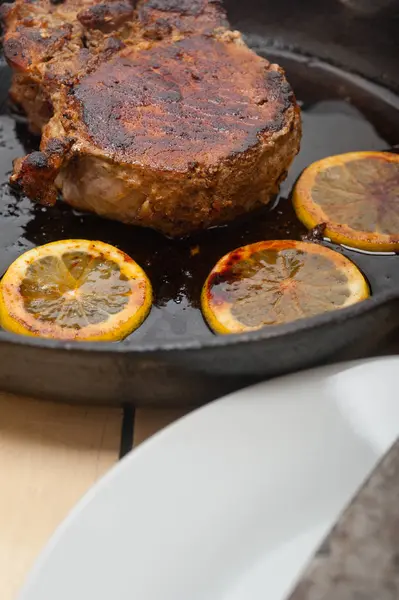 Pork chop seared on iron skillet — Stock Photo, Image